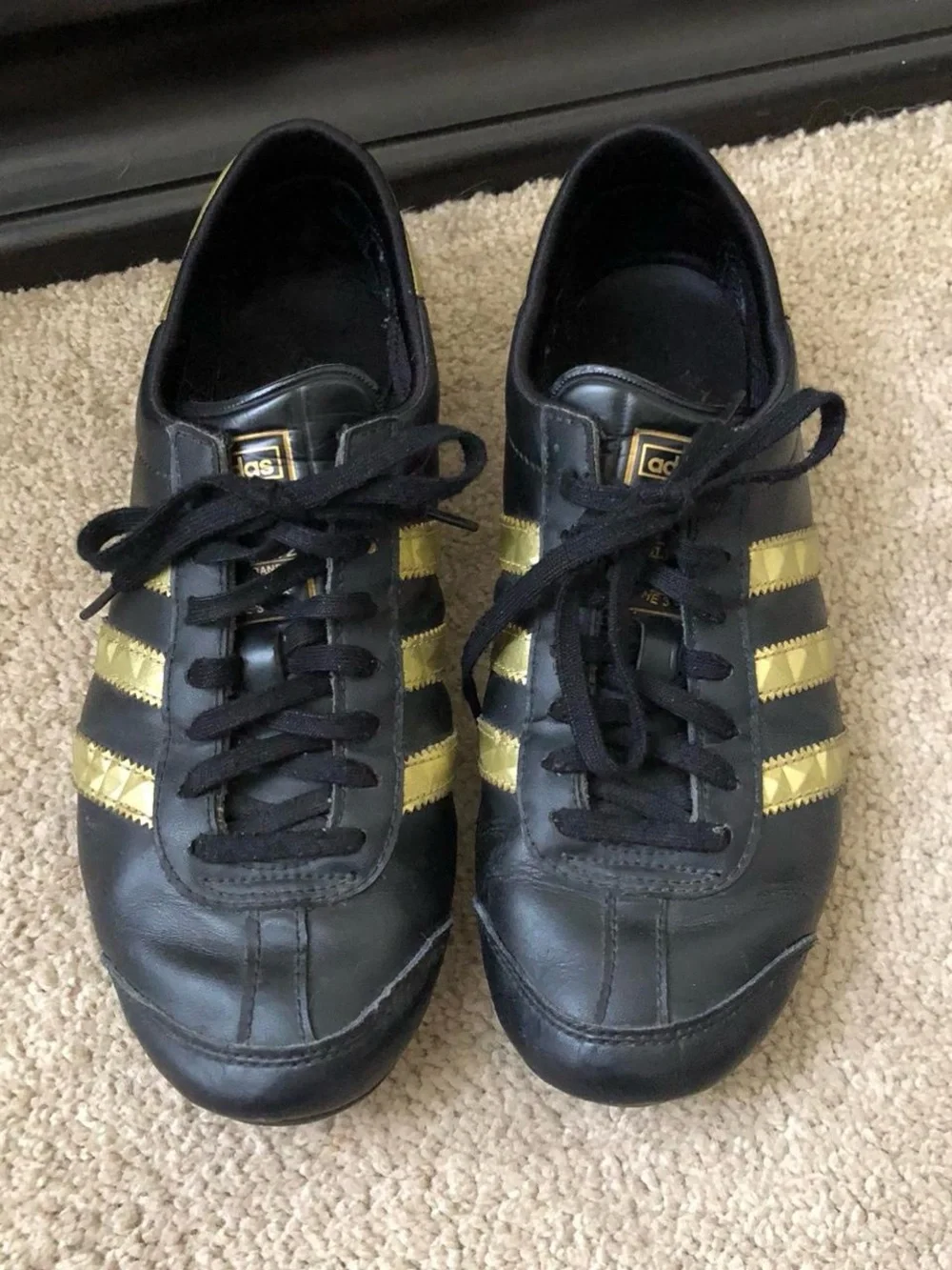 adidas Women’s Black Sneakers with Gold Stripes